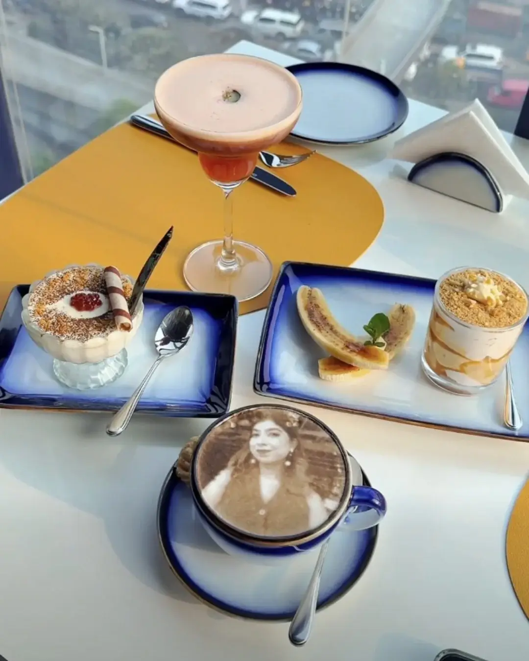 Photo engraved latte Dhaka served with a table of desserts
