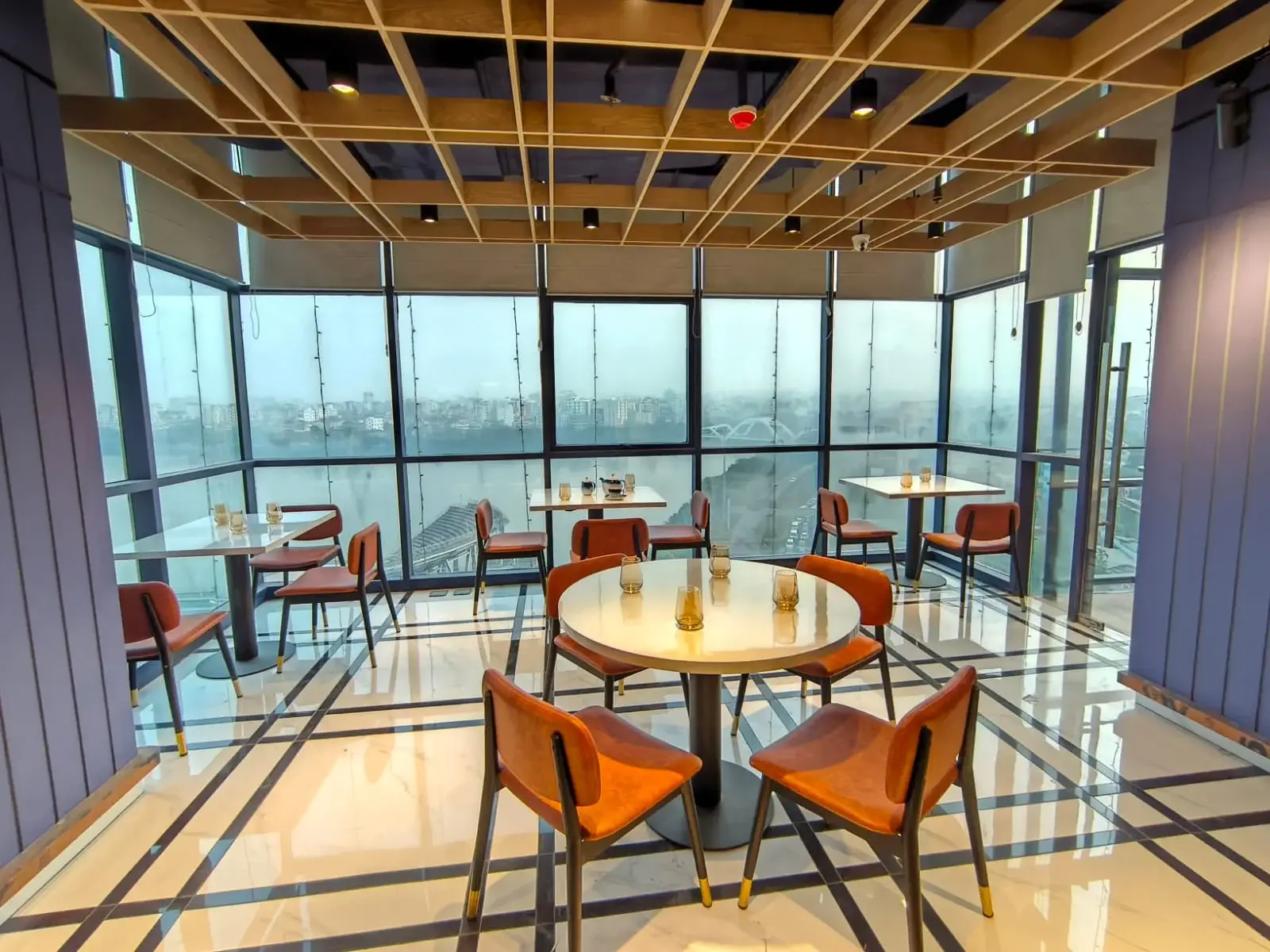 Lake view restaurant Dhaka with round table and city skyline