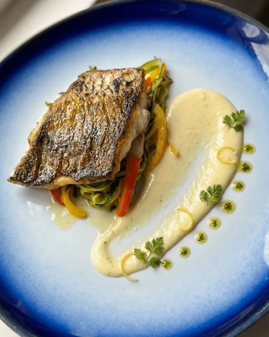 Best grilled fish in Dhaka plated with vegetables and sauce